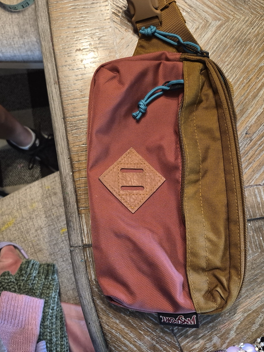 JanSport Waisted Pack features a two-tone design with a brown ballistic nylon bo
